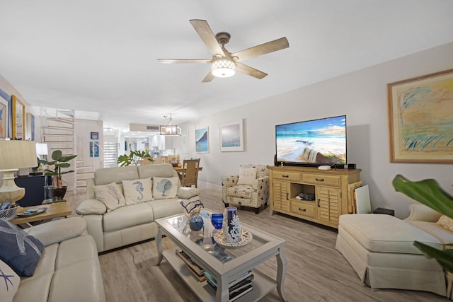 living room featuring ceiling fan and light wood-type flooring