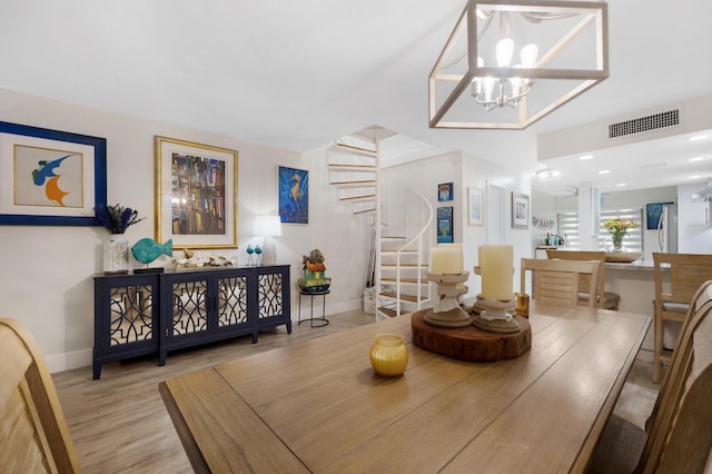 dining room featuring a chandelier and light hardwood / wood-style floors