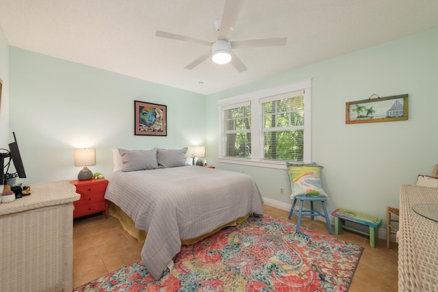 bedroom with ceiling fan and light tile patterned floors