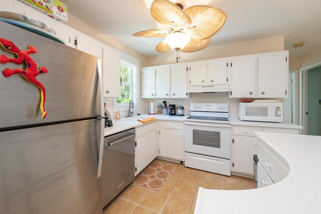 kitchen with white cabinetry, sink, light tile patterned floors, ceiling fan, and stainless steel appliances