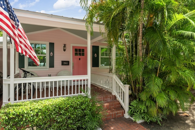 view of exterior entry featuring a porch