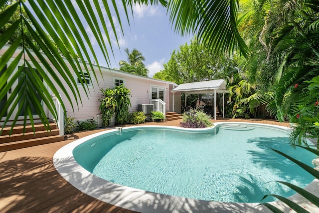 view of pool with a wooden deck, a gazebo, and central AC