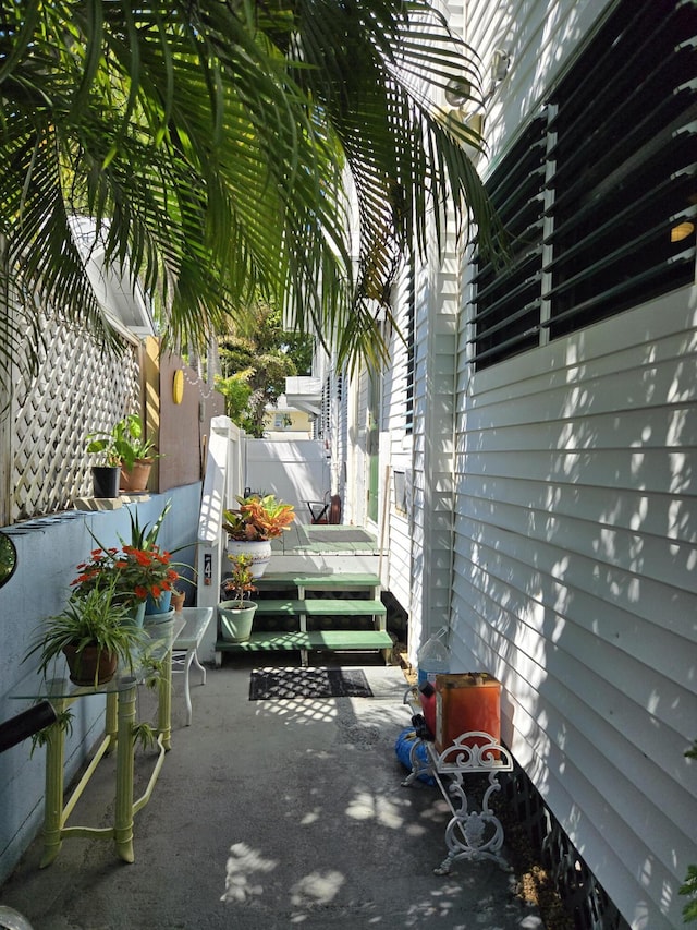 view of patio featuring a wooden deck and fence