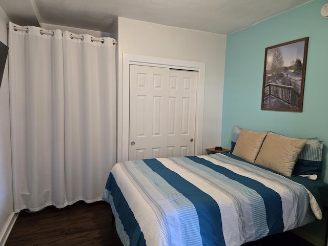 bedroom with a closet and dark wood-type flooring