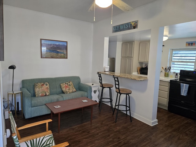 living area featuring dark wood-style floors and a ceiling fan