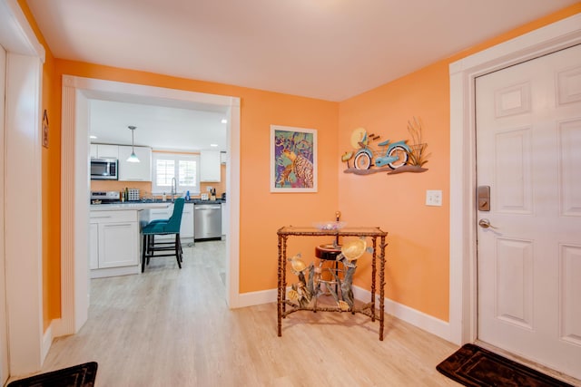24 Cactus Dr, Big Coppitt, FL 33040 - foyer entrance featuring light wood-style floors and baseboards