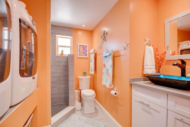 24 Cactus Dr, Big Coppitt, FL 33040 - bathroom with baseboards, washing machine and dryer, toilet, a tile shower, and vanity