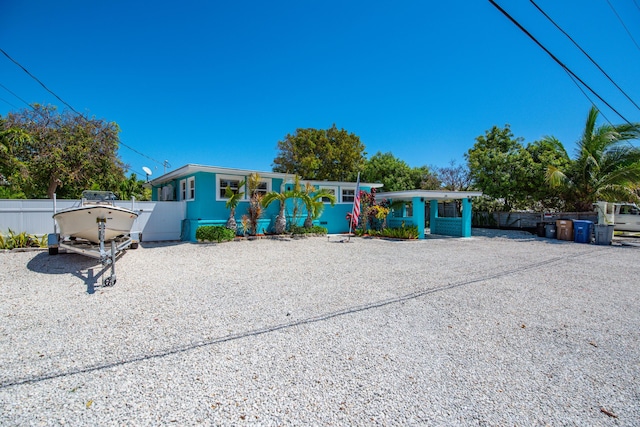 24 Cactus Dr, Big Coppitt, FL 33040 - view of front of house with gravel driveway and fence