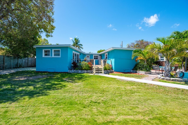 24 Cactus Dr, Big Coppitt, FL 33040 - view of front of house with a front lawn, fence, and a patio area