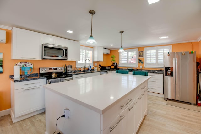 24 Cactus Dr, Big Coppitt, FL 33040 - kitchen featuring light wood-style flooring, appliances with stainless steel finishes, a wall mounted air conditioner, and a sink