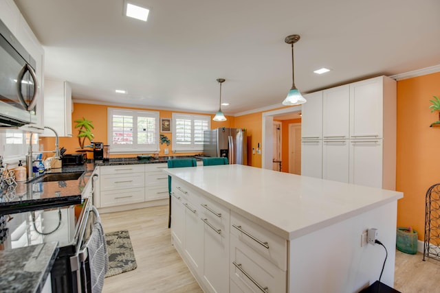 24 Cactus Dr, Big Coppitt, FL 33040 - kitchen featuring ornamental molding, light wood-style floors, and stainless steel appliances