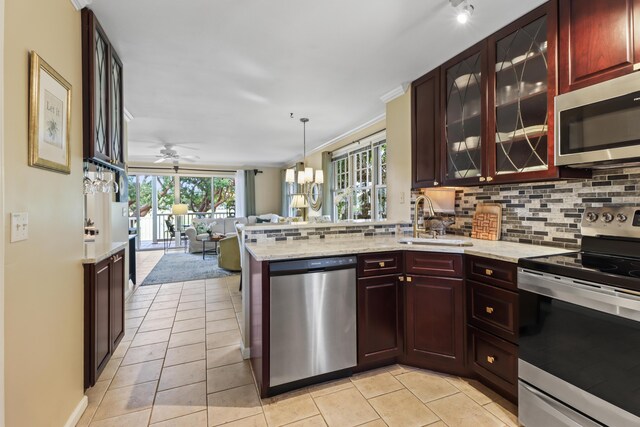 11 Kestral Way, Key West, FL 33040 - kitchen with sink, appliances with stainless steel finishes, tasteful backsplash, decorative light fixtures, and kitchen peninsula