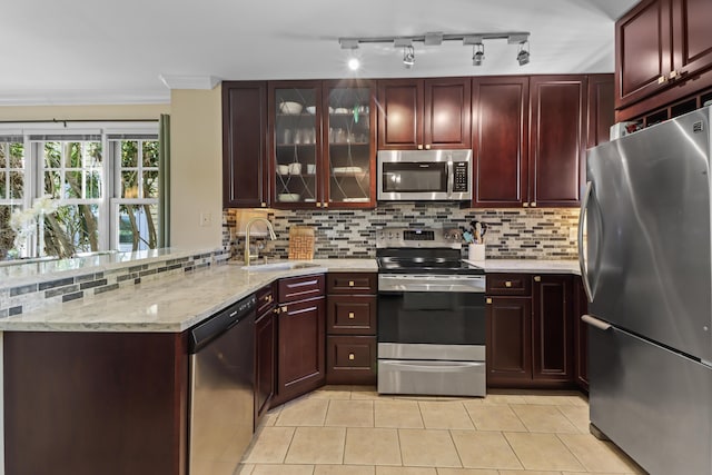 11 Kestral Way, Key West, FL 33040 - kitchen with sink, backsplash, light tile patterned flooring, and appliances with stainless steel finishes