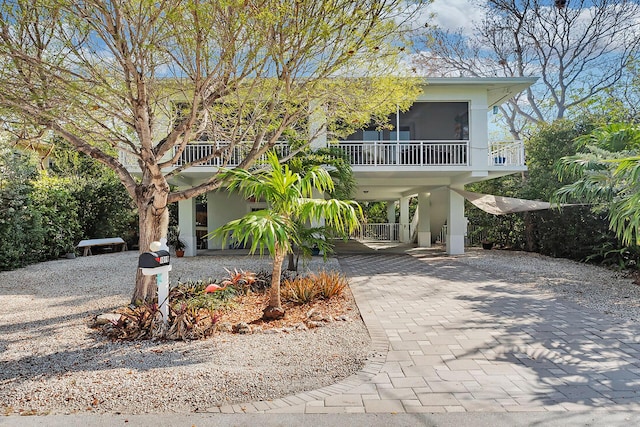 1019 Snapper Ln, Key Largo, FL 33037 - coastal inspired home with a carport, decorative driveway, a sunroom, and stucco siding