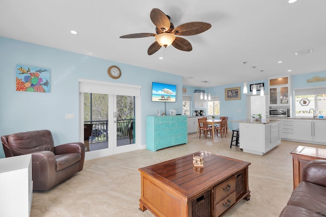 living area featuring recessed lighting and ceiling fan