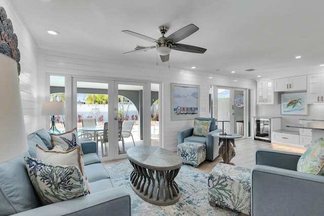 living room with recessed lighting, light wood-style floors, ceiling fan, and wine cooler