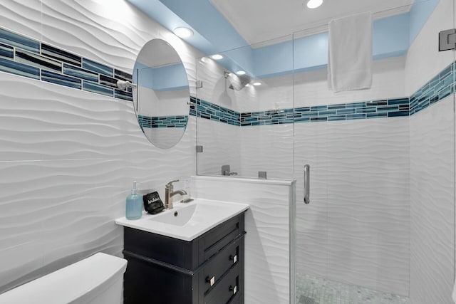 full bathroom featuring toilet, tile walls, a stall shower, recessed lighting, and vanity