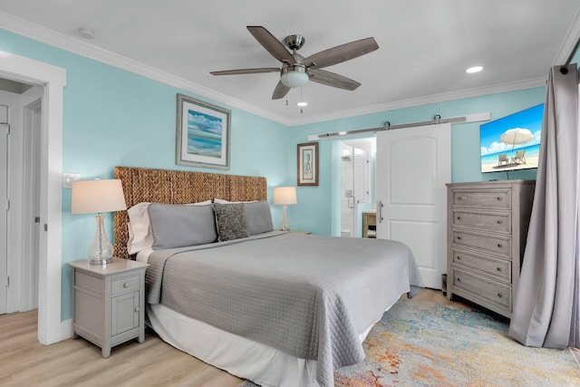 bedroom featuring recessed lighting, crown molding, ensuite bathroom, and light wood-type flooring