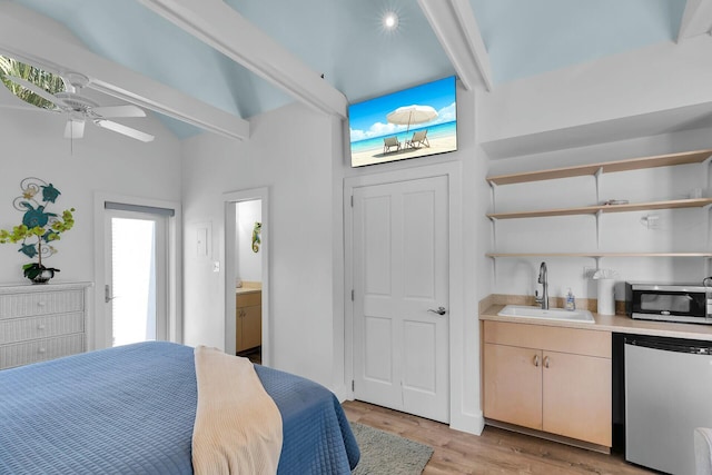 bedroom with light wood finished floors, a sink, ensuite bath, beam ceiling, and indoor wet bar