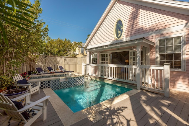 view of swimming pool featuring fence, a fenced in pool, and a wooden deck