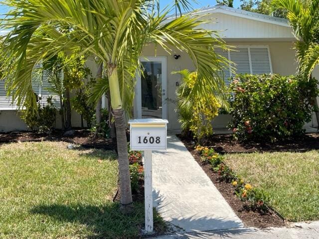 1608 Venetian Dr, Key West, FL 33040 - doorway to property featuring a yard and stucco siding