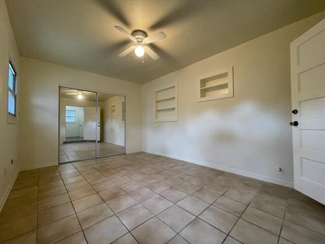 1608 Venetian Dr, Key West, FL 33040 - unfurnished bedroom featuring light tile patterned floors, a closet, and a ceiling fan