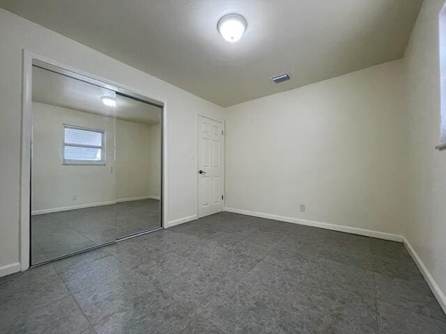 1608 Venetian Dr, Key West, FL 33040 - unfurnished bedroom with baseboards and a closet
