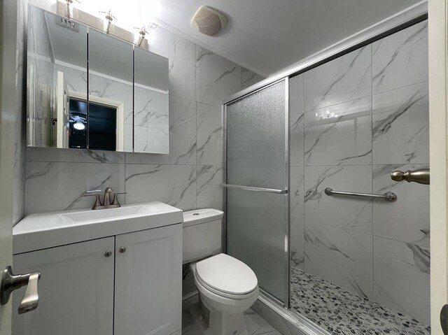 1608 Venetian Dr, Key West, FL 33040 - bathroom with tile walls, a marble finish shower, vanity, and marble finish flooring