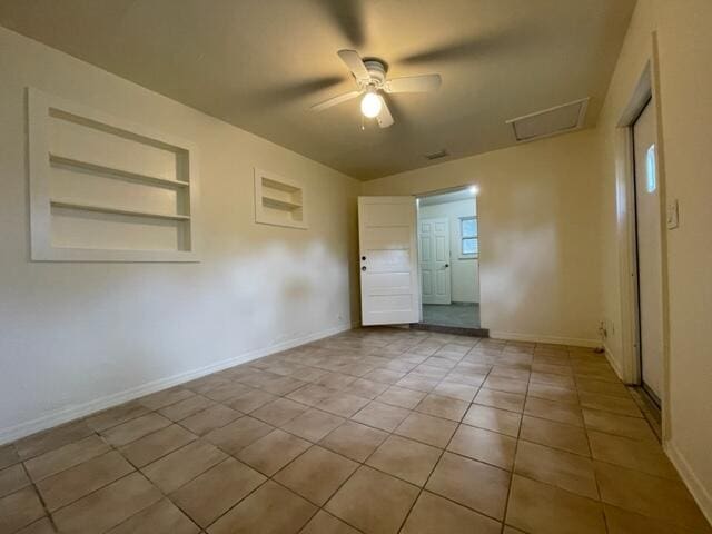 1608 Venetian Dr, Key West, FL 33040 - empty room with built in shelves, attic access, a ceiling fan, and light tile patterned floors