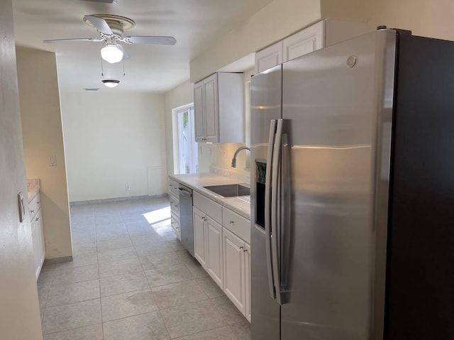 1608 Venetian Dr, Key West, FL 33040 - kitchen featuring stainless steel appliances, light countertops, ceiling fan, white cabinets, and light tile patterned flooring