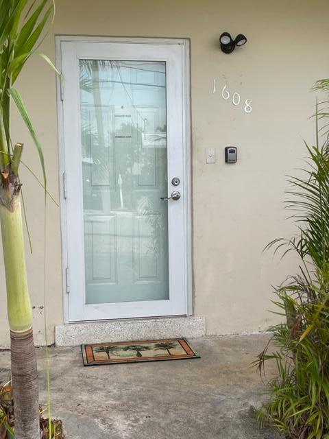 1608 Venetian Dr, Key West, FL 33040 - doorway to property with stucco siding