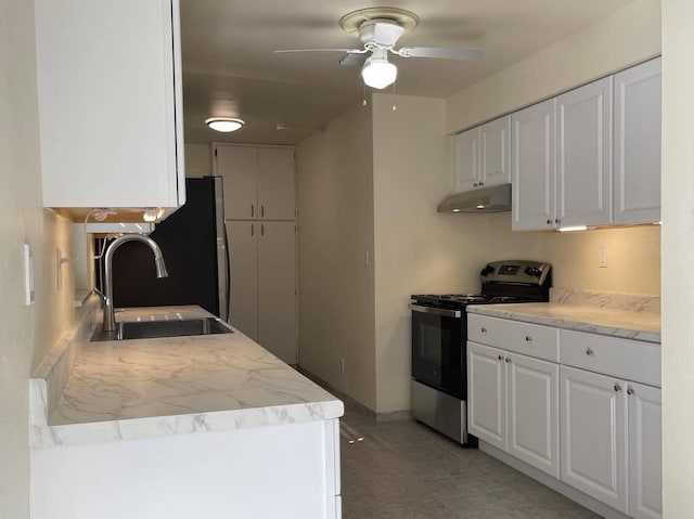 1608 Venetian Dr, Key West, FL 33040 - kitchen with stainless steel electric range, under cabinet range hood, white cabinets, and ceiling fan