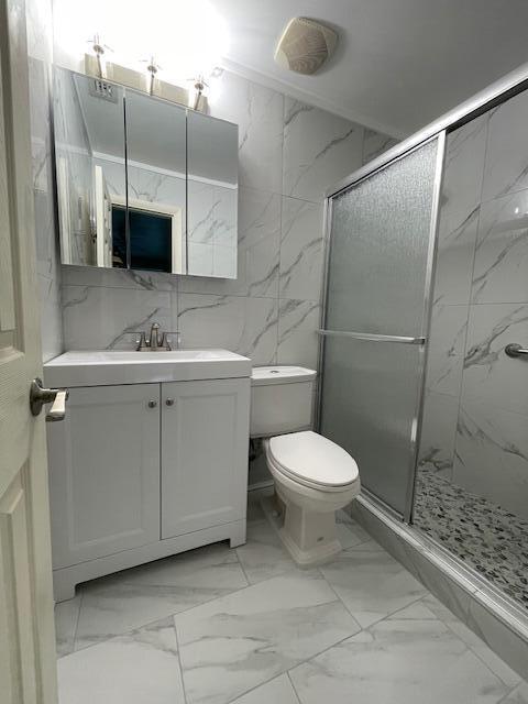 1608 Venetian Dr, Key West, FL 33040 - full bathroom with marble look tiles, vanity, and a marble finish shower