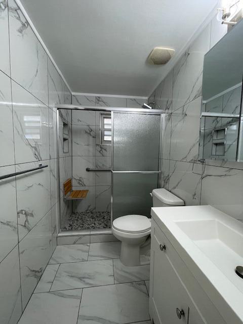 1608 Venetian Dr, Key West, FL 33040 - bathroom with vanity, a marble finish shower, and marble finish floors