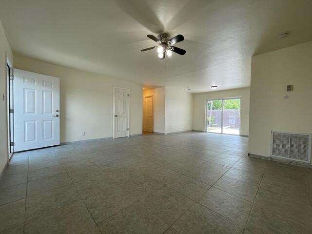 1608 Venetian Dr, Key West, FL 33040 - unfurnished living room featuring ceiling fan and baseboards