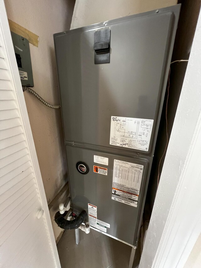 utility room featuring heating unit