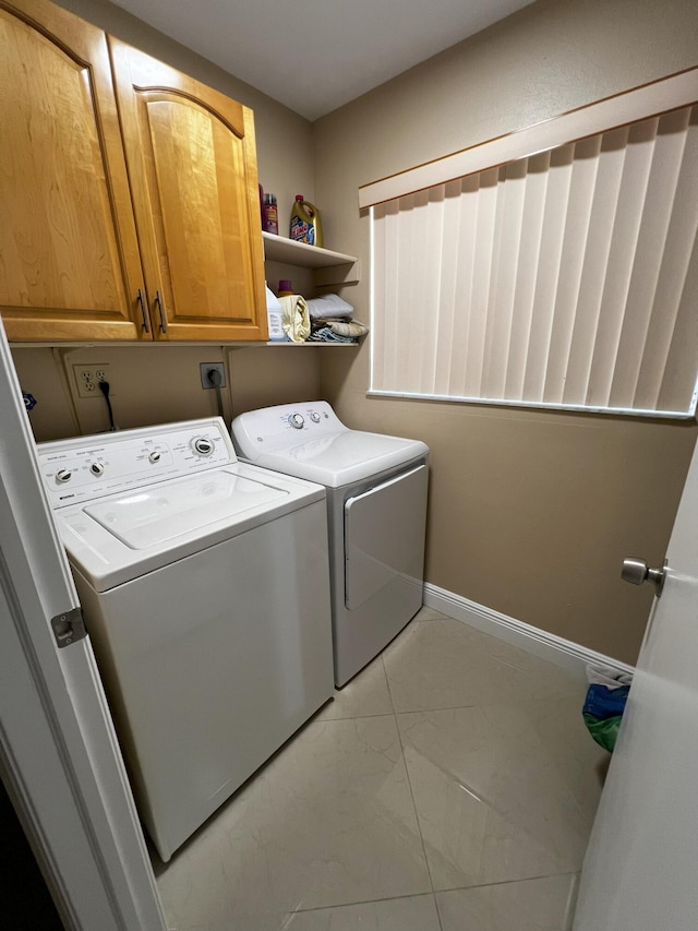 laundry area with cabinets and washing machine and clothes dryer