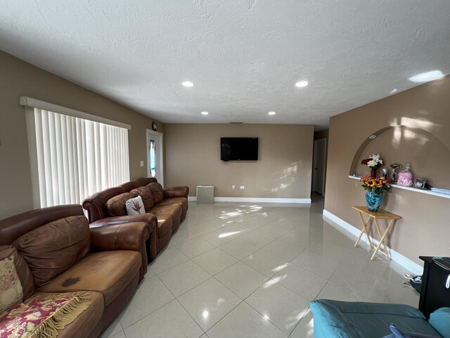 tiled living room with a textured ceiling