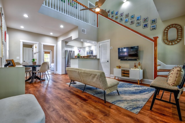 606 Truman Ave Unit 1, Key West, FL 33040 - living area with wood finished floors, baseboards, recessed lighting, ceiling fan, and a towering ceiling