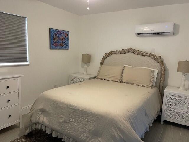 bedroom with a wall mounted air conditioner