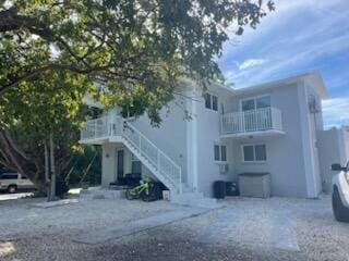 exterior space with a balcony, stairs, and a garage