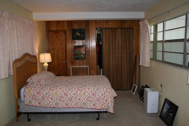 bedroom with a textured ceiling and carpet