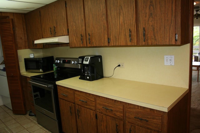 kitchen with stainless steel range with electric cooktop and light tile patterned floors