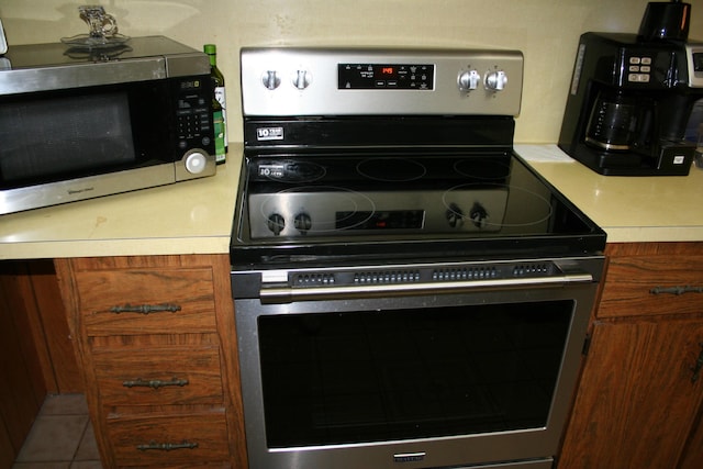 kitchen featuring stainless steel appliances and tile patterned flooring