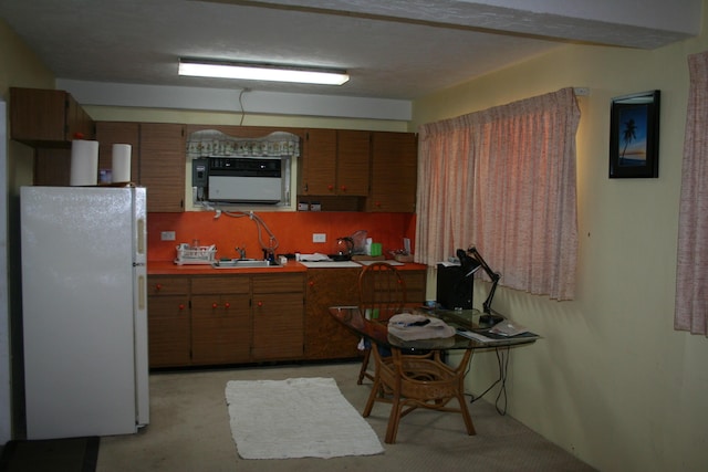 kitchen with sink and white fridge