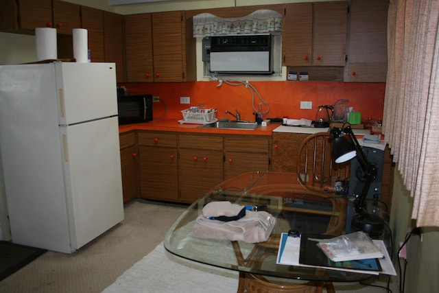 kitchen with sink and white refrigerator