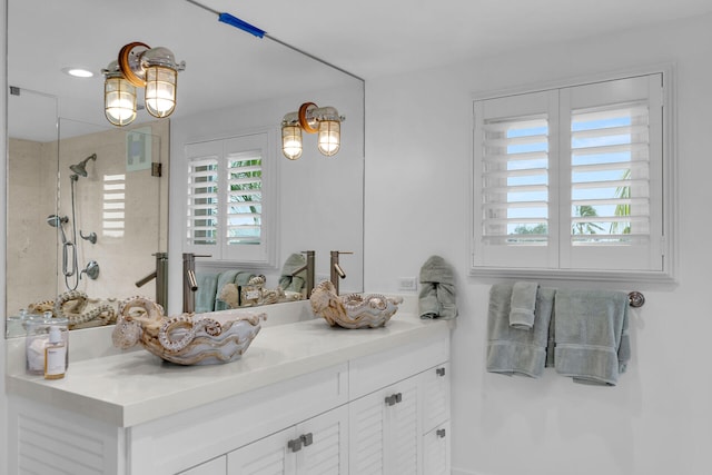 bathroom with vanity and a shower with shower door