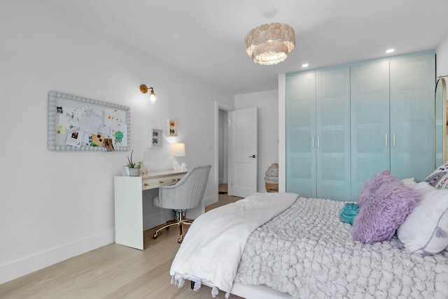 bedroom with wood finished floors and baseboards