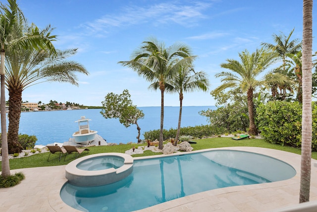 view of pool featuring a water view and an in ground hot tub