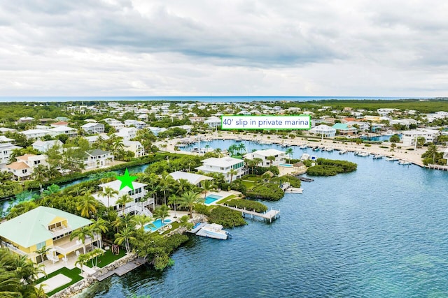 bird's eye view featuring a water view and a residential view